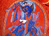 Tibet Guge 06 Tsaparang White Temple 03 01 Mahakala Below Hayagrivas outstretched right arm is a beautiful painting of blue Mahakala, a wrathful Tantric deity and manifestation of Avalokiteshvara (Tib. Chenrezig). He is blue with fanged teeth and a tiara of skulls, wears richly decorated robes, holds a staff in his right hand and a skull cup brimming with blood in his left. Photo - Weyer/Aschoff: Tsaparang, Tibets Grosses Geheimnis.